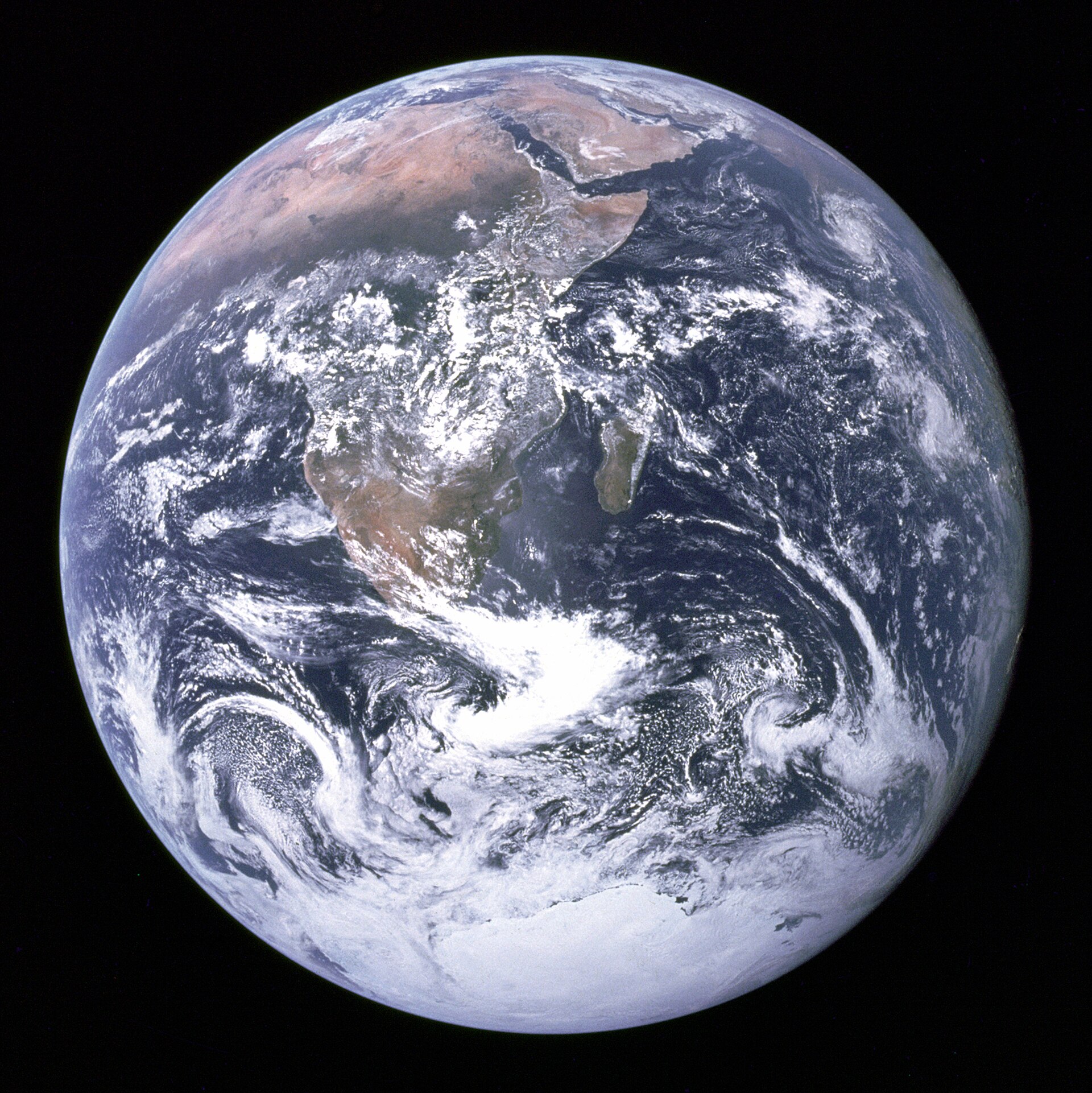 The fully lit disc of the Earth against black space, showing Africa, Antarctica and swirling clouds