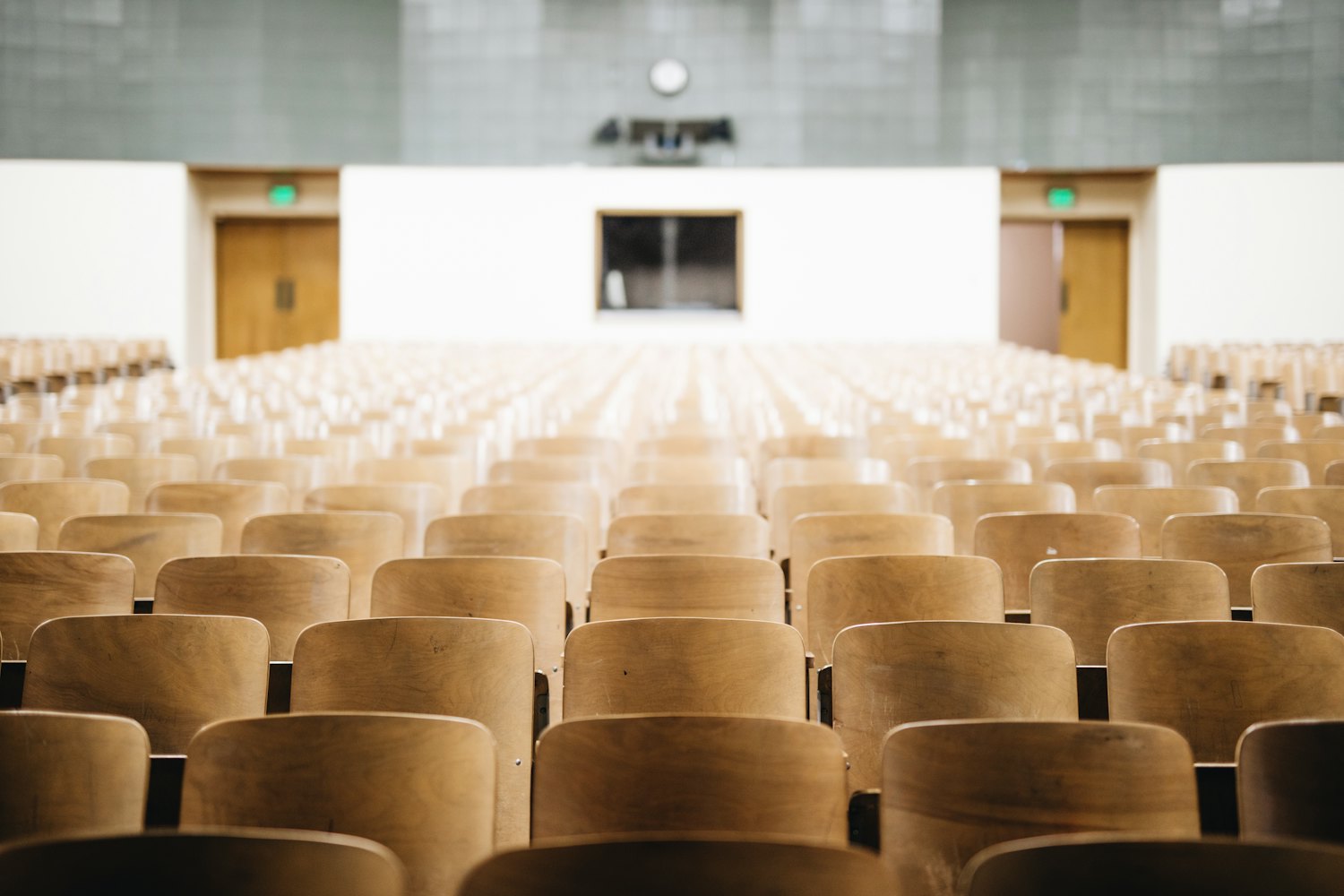 Rows of wooden seats in a quiet examination hall